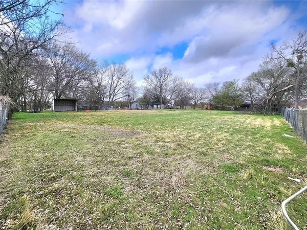 a view of a field with an trees