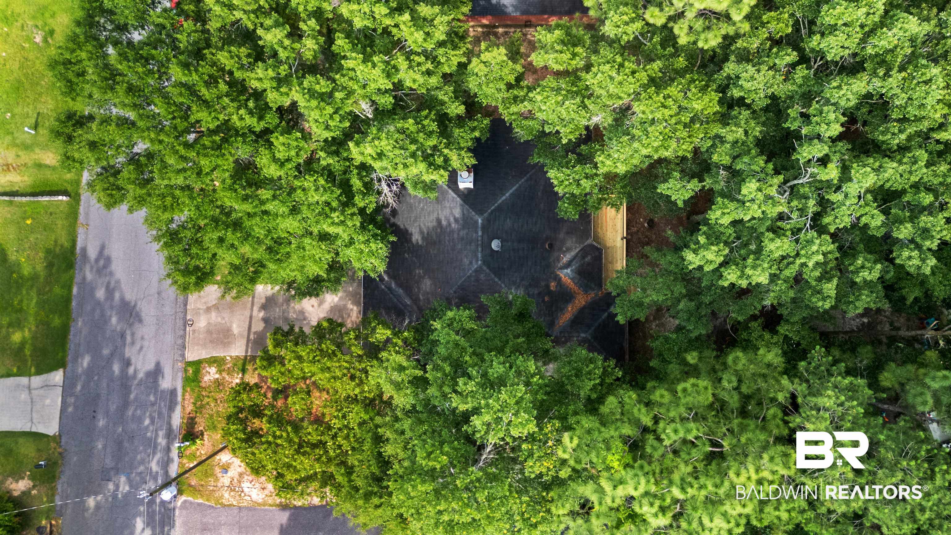 153 Lakeview Loop Daphne, AL 36526 - Photo 55 of 56 Surrounded by a canopy of mature trees, the property enjoys a peaceful setting that feels tucked away from the everyday hustle.