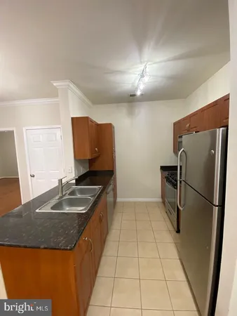 a stove top oven sitting inside of a kitchen