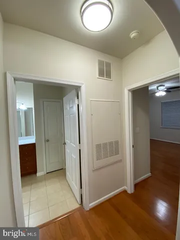a view of empty room with wooden floor