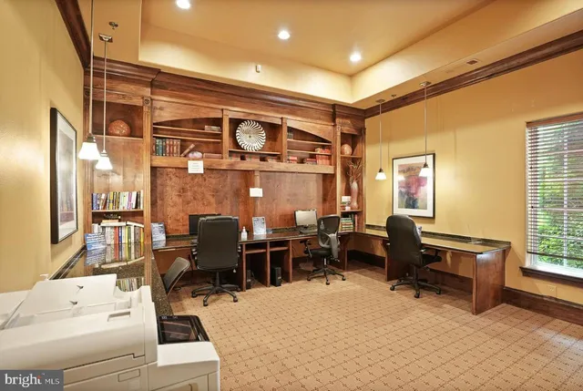 a living room with lots of furniture and a large window