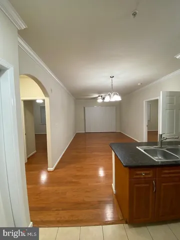 a kitchen with a sink a refrigerator and wooden cabinets