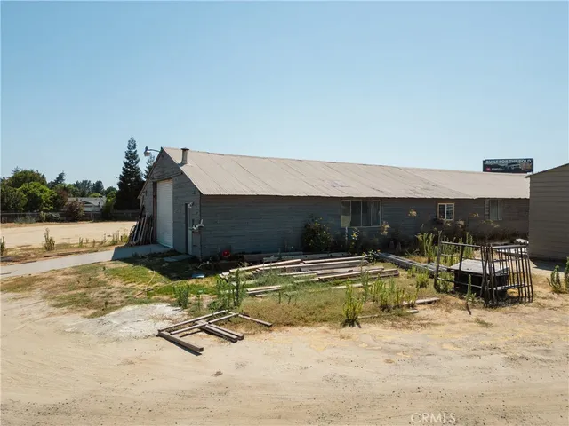 a view of a patio with table and chairs a barbeque with potted plants and big yard