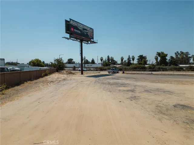 a view of swimming pool with outdoor seating and trees in the background