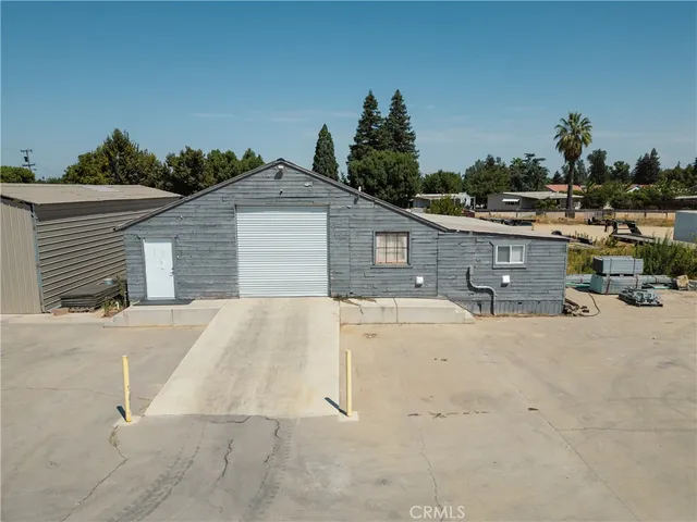 a spacious bedroom with a bed and a table chair