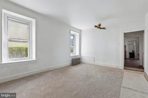 an empty room with windows and closet