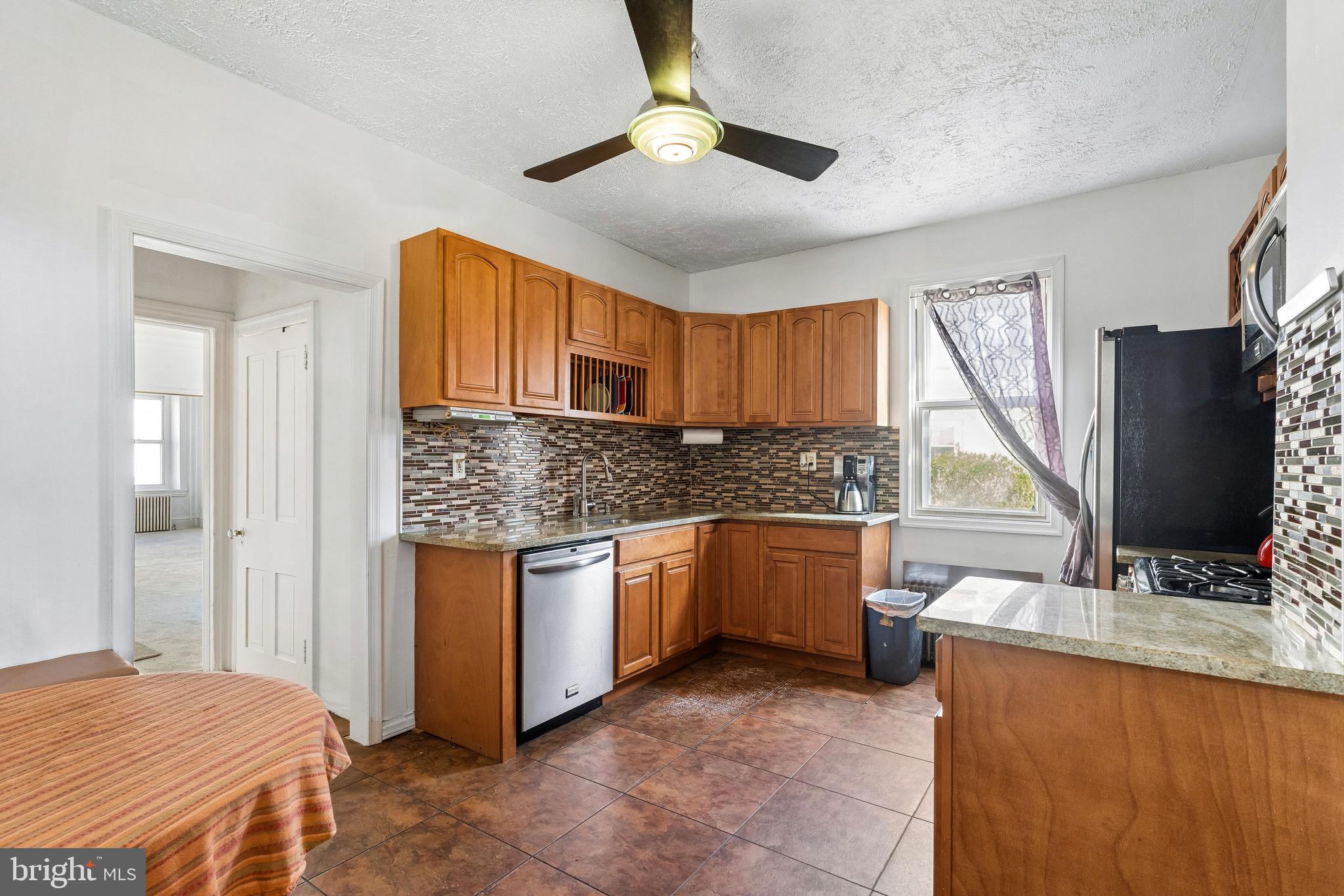 439 Lemonte Street Philadelphia, PA 19128 - Photo 16 of 42 a kitchen with stainless steel appliances granite countertop a sink stove and refrigerator