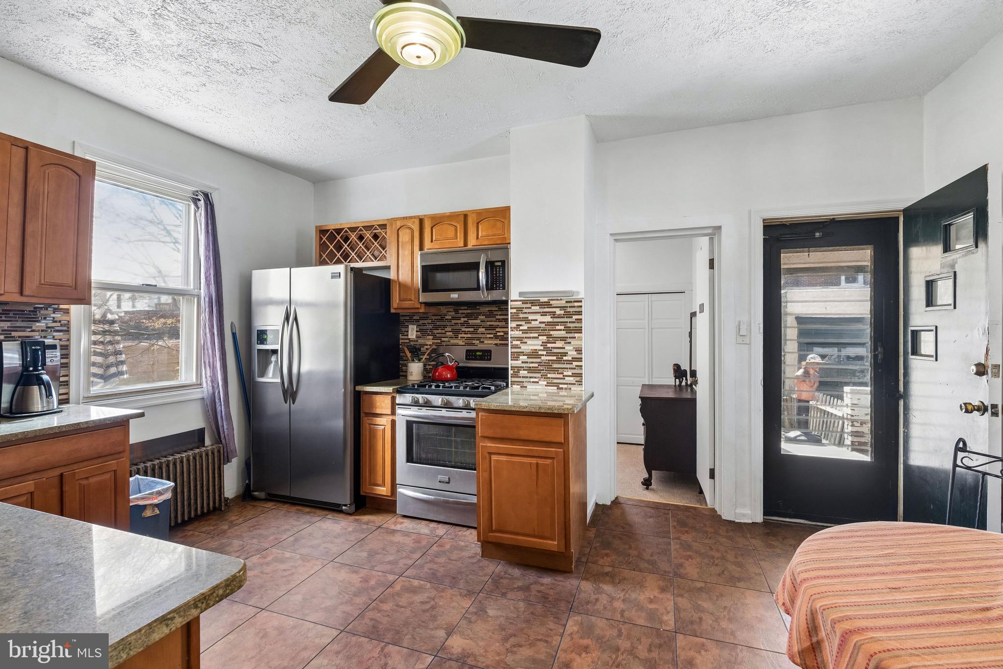 439 Lemonte Street Philadelphia, PA 19128 - Photo 17 of 42 a kitchen with stainless steel appliances granite countertop a refrigerator a stove and a sink