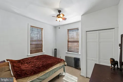 a living room with a bed furniture and a window