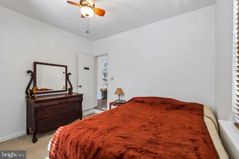 a bedroom with a bed and a desk