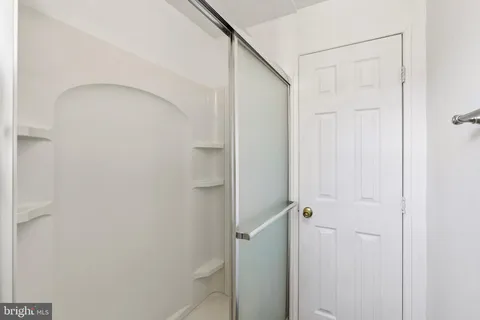 a white toilet sitting next to a shower curtain