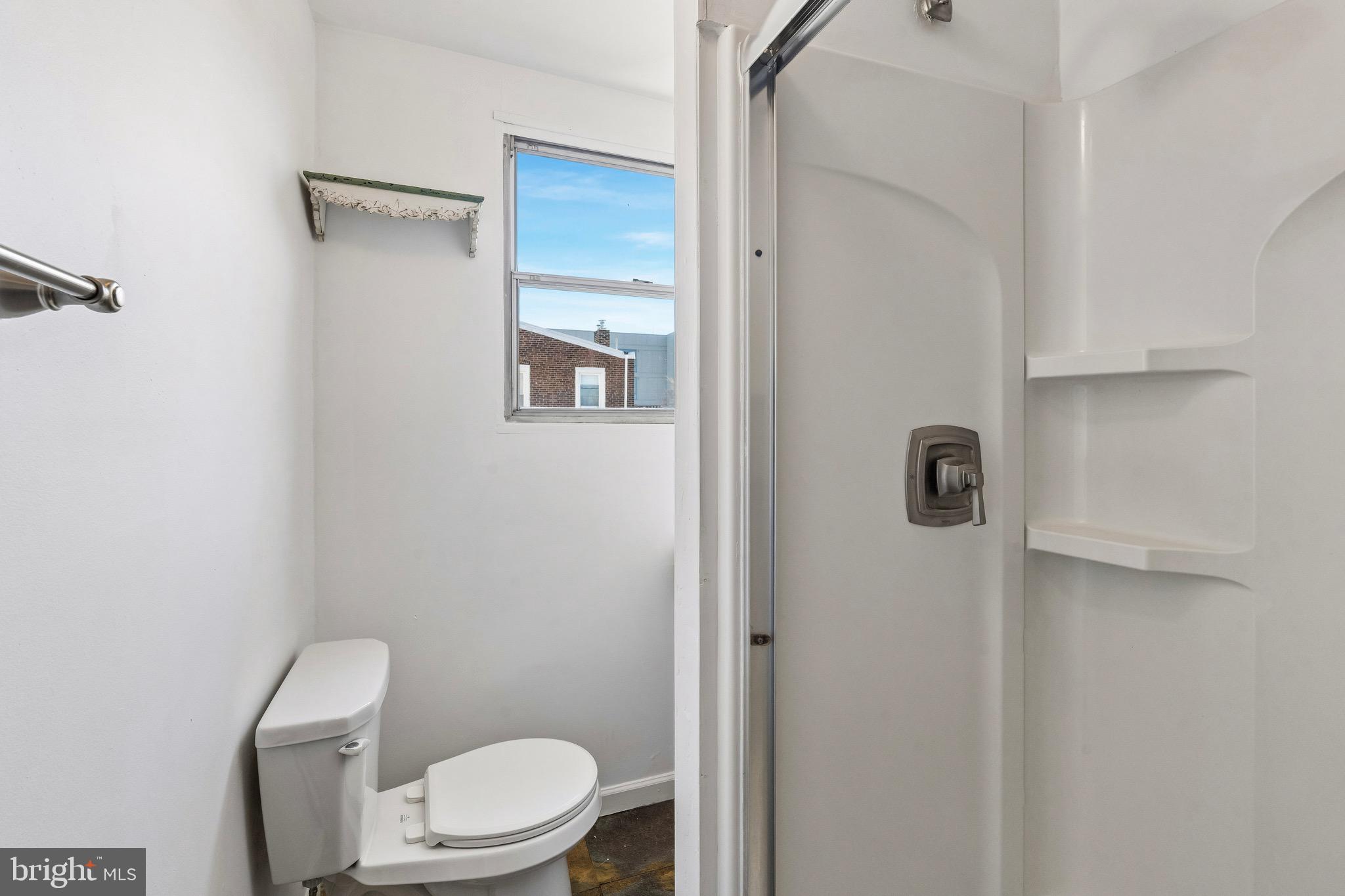 439 Lemonte Street Philadelphia, PA 19128 - Photo 24 of 42 a white toilet sitting next to a shower curtain