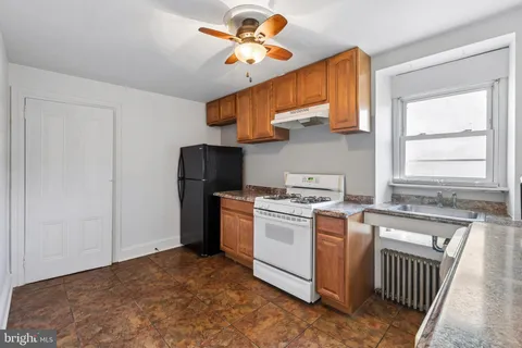an empty room with a window and a ceiling fan