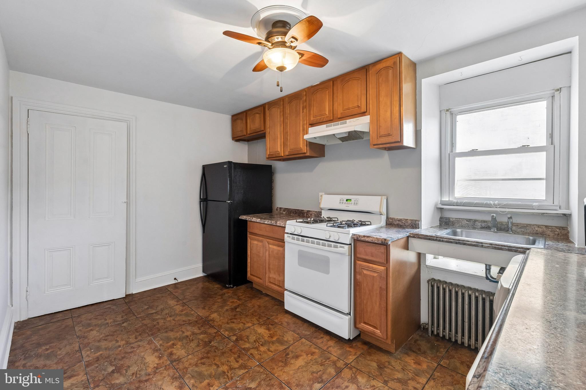 439 Lemonte Street Philadelphia, PA 19128 - Photo 25 of 42 a kitchen with a stove a refrigerator and a sink
