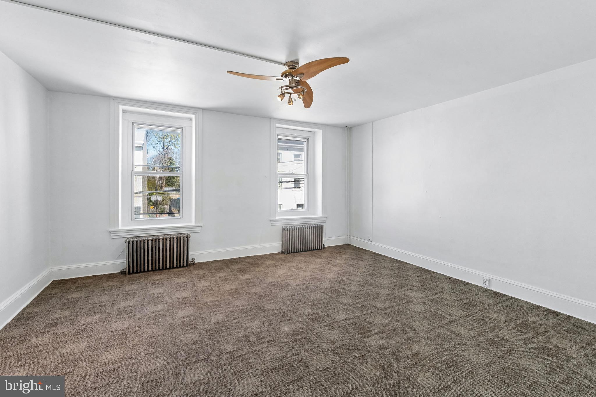 439 Lemonte Street Philadelphia, PA 19128 - Photo 26 of 42 an empty room with a window and a ceiling fan