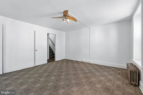 a view of a hallway with wooden floor and entryway