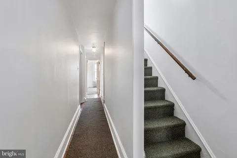 a view of a hallway with a wooden floor