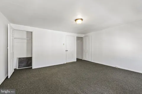 an empty room with a empty space and windows