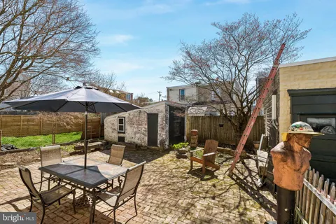 a view of a patio with a table and chairs under an umbrella