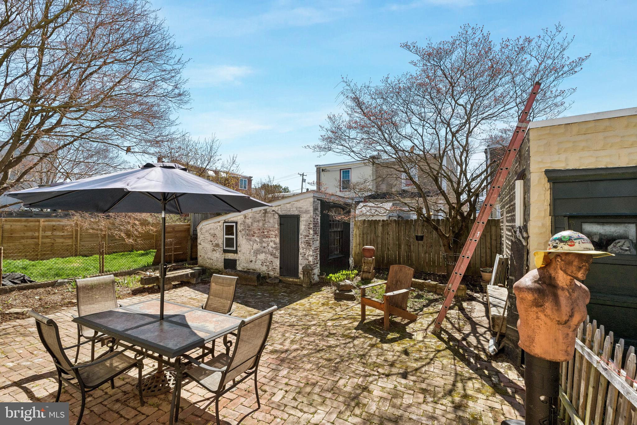 439 Lemonte Street Philadelphia, PA 19128 - Photo 38 of 42 a patio with a table and chairs under an umbrella