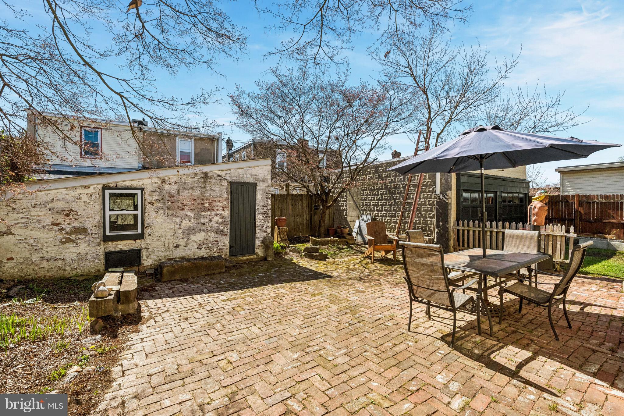 439 Lemonte Street Philadelphia, PA 19128 - Photo 39 of 42 a view of a patio with a table and chairs under an umbrella