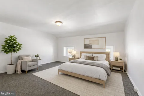 a bedroom with a bed and a couch