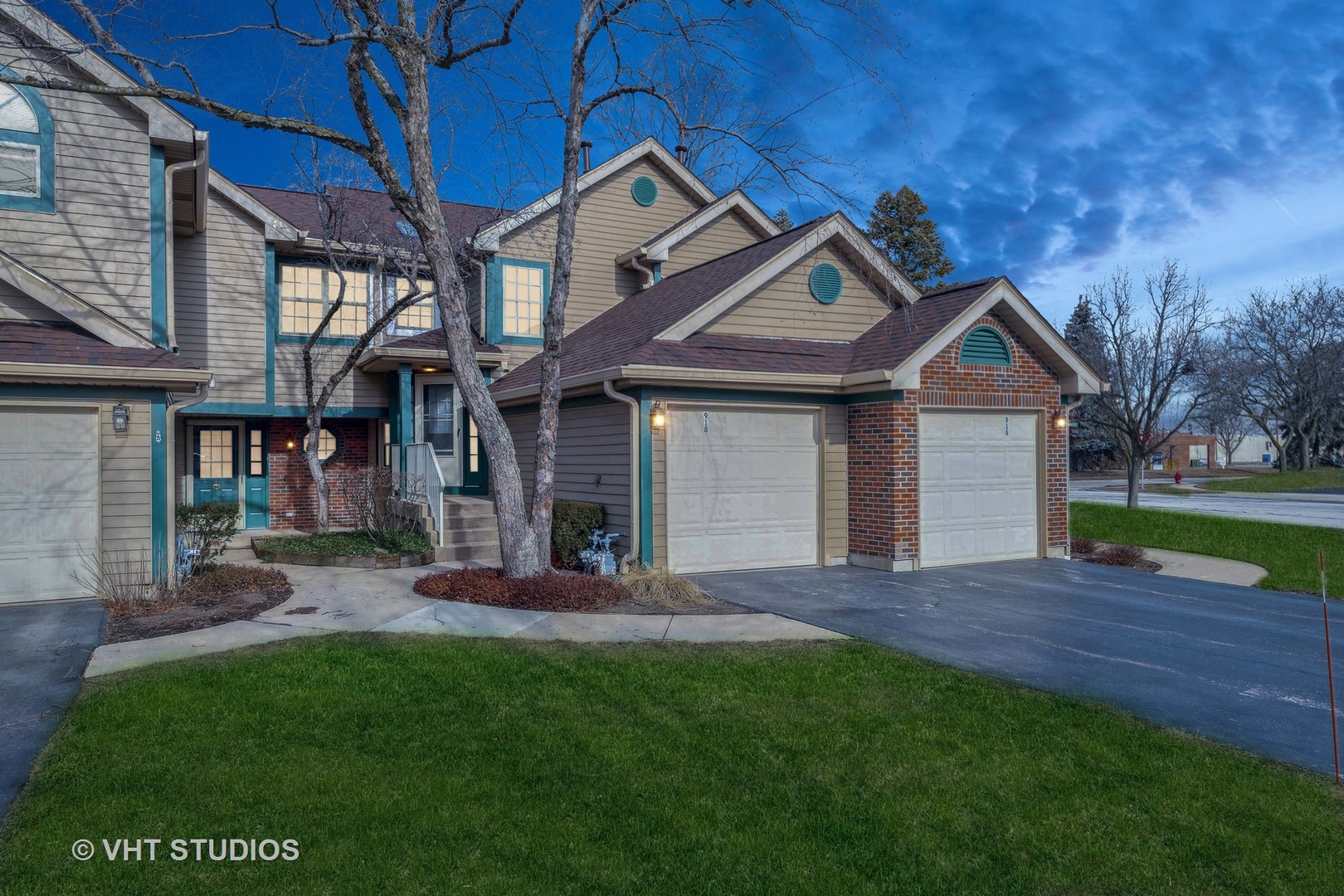 918 Ridgefield Lane Wheeling, IL 60090 - Photo 19 of 22 a front view of a house with a garden and yard