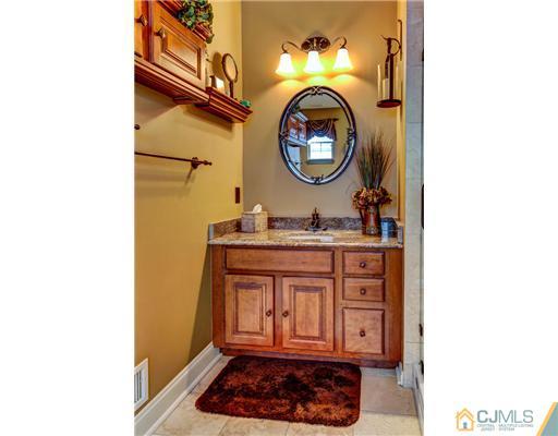 16 Pebble Creek Road Dayton, NJ 08810 - Photo 15 of 25 a bathroom with a sink and a mirror