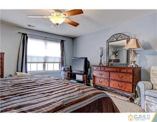 16 Pebble Creek Road Dayton, NJ 08810 - Photo 16 of 25 a bedroom with a bed and a chandelier