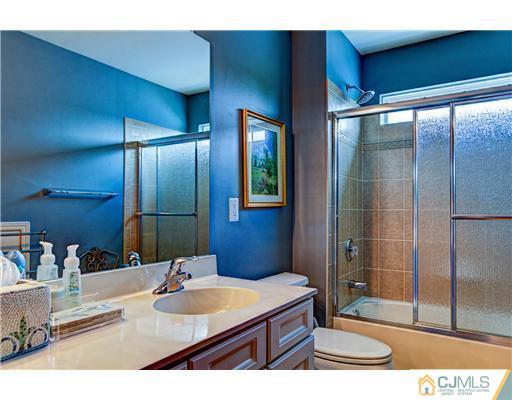 16 Pebble Creek Road Dayton, NJ 08810 - Photo 17 of 25 a bathroom with a sink a toilet and shower