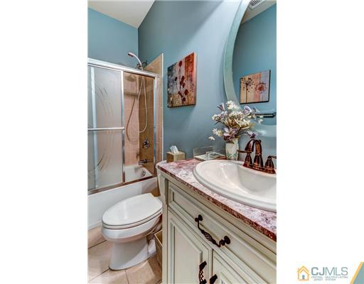 16 Pebble Creek Road Dayton, NJ 08810 - Photo 19 of 25 a bathroom with a sink a toilet and shower