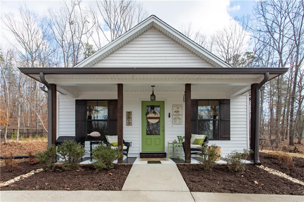 7621 Maple Place Murrayville, GA 30564 - Photo 1 of 1 a front view of a house with garden