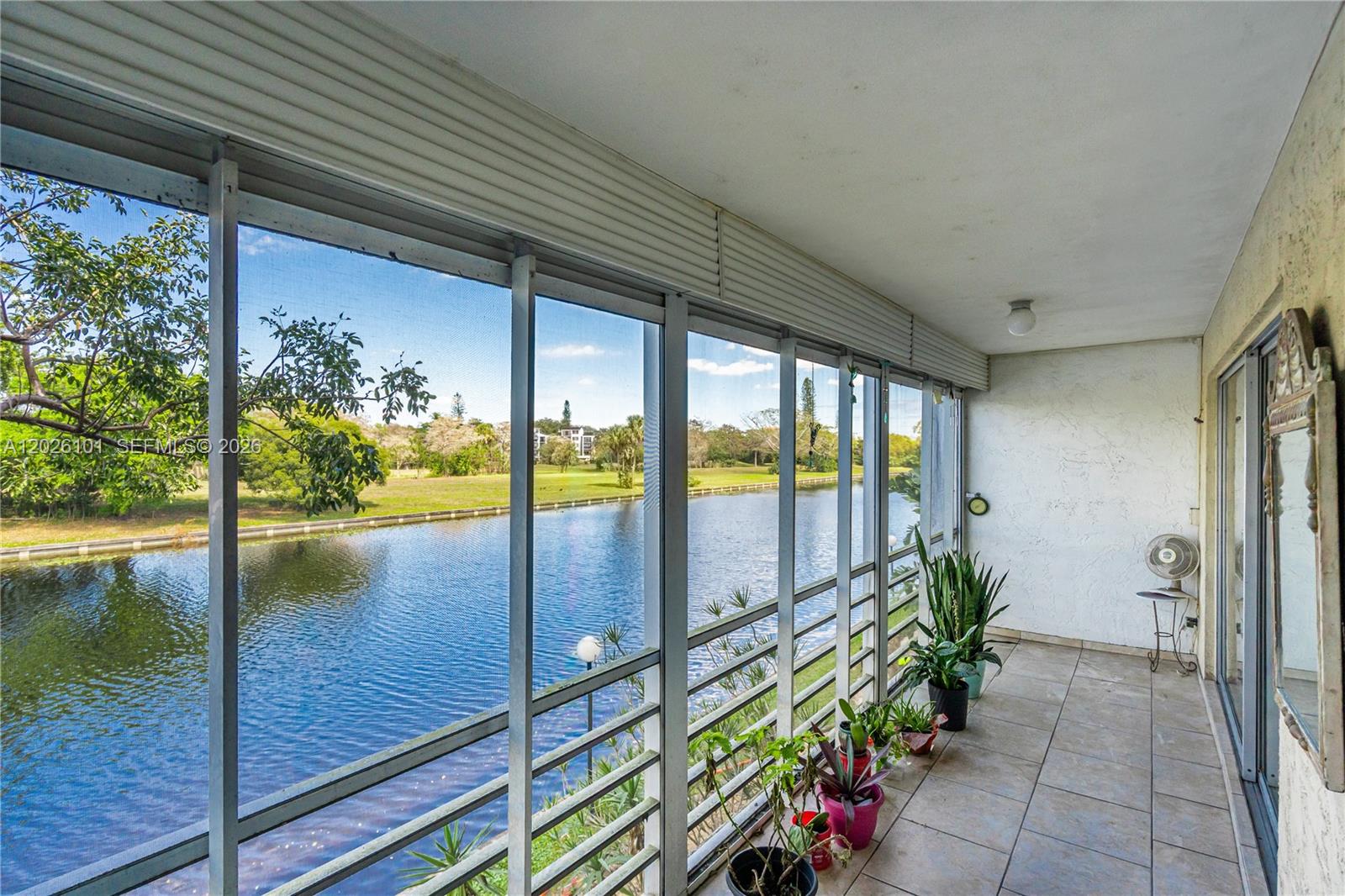 3551 Inverrary Drive, Unit 208 Lauderhill, FL 33319 - Photo 18 of 34 a lobby with a floor to ceiling window and wooden floor