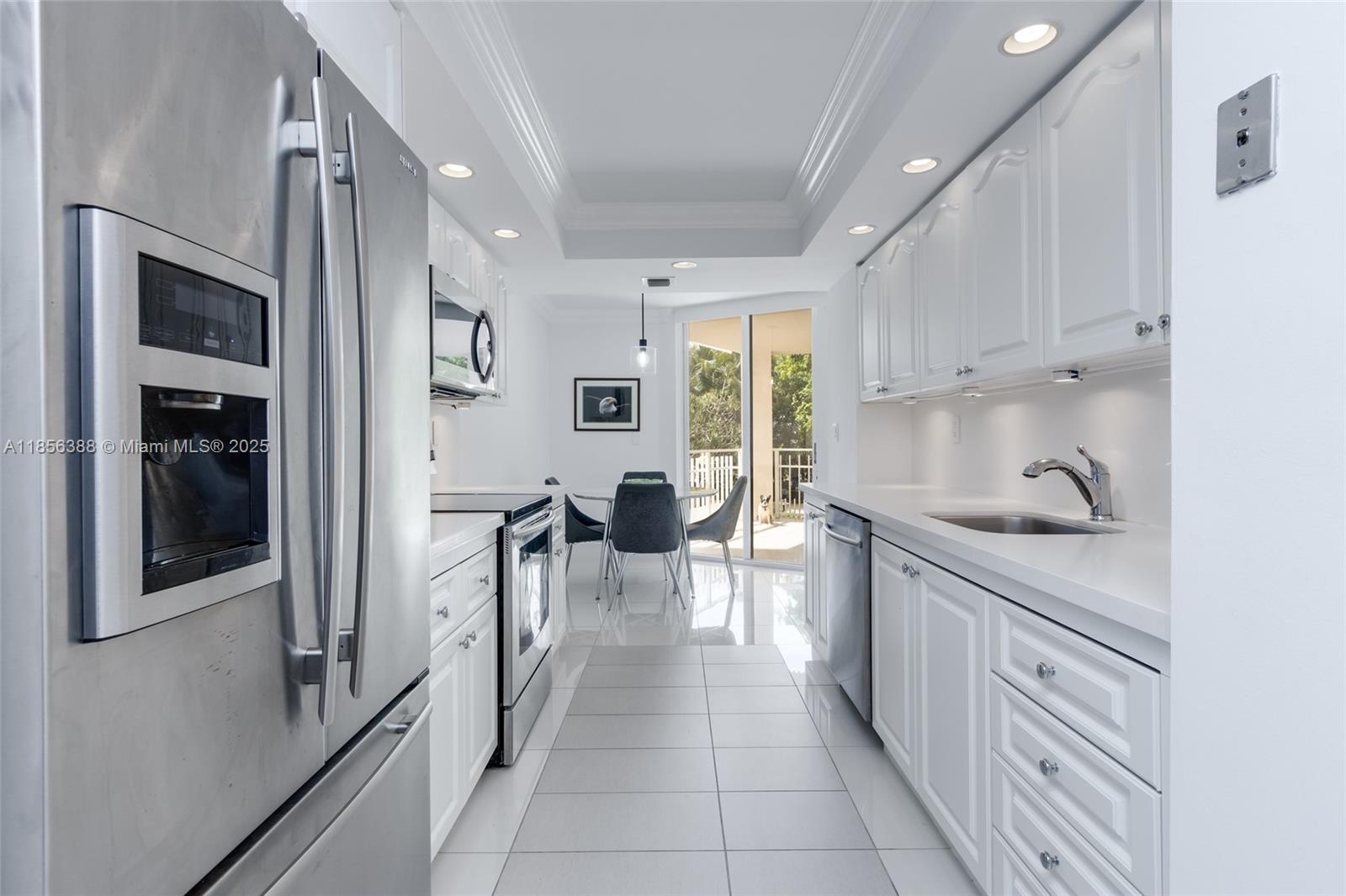 2000 Towerside Terrace, Unit 406 Miami, FL 33138 - Photo 12 of 56 a kitchen with stainless steel appliances granite countertop a refrigerator and a sink