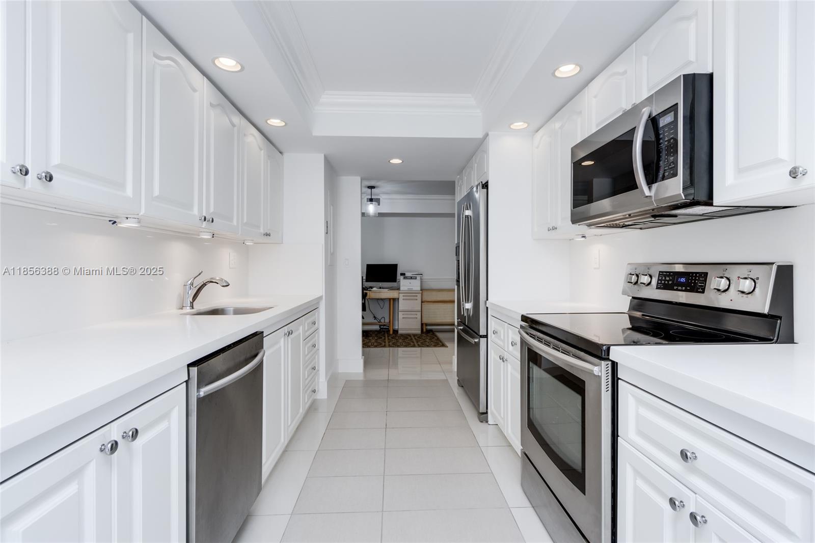 2000 Towerside Terrace, Unit 406 Miami, FL 33138 - Photo 14 of 56 a kitchen with stainless steel appliances granite countertop a sink and a stove