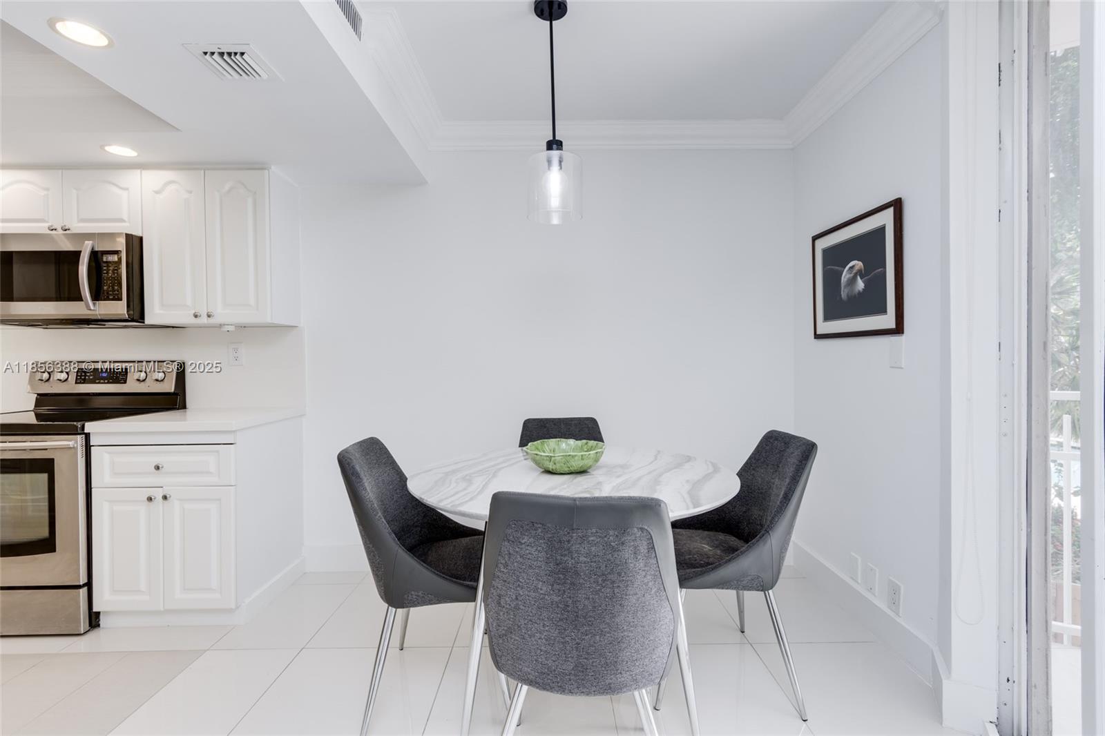 2000 Towerside Terrace, Unit 406 Miami, FL 33138 - Photo 16 of 56 a dining room with furniture and window