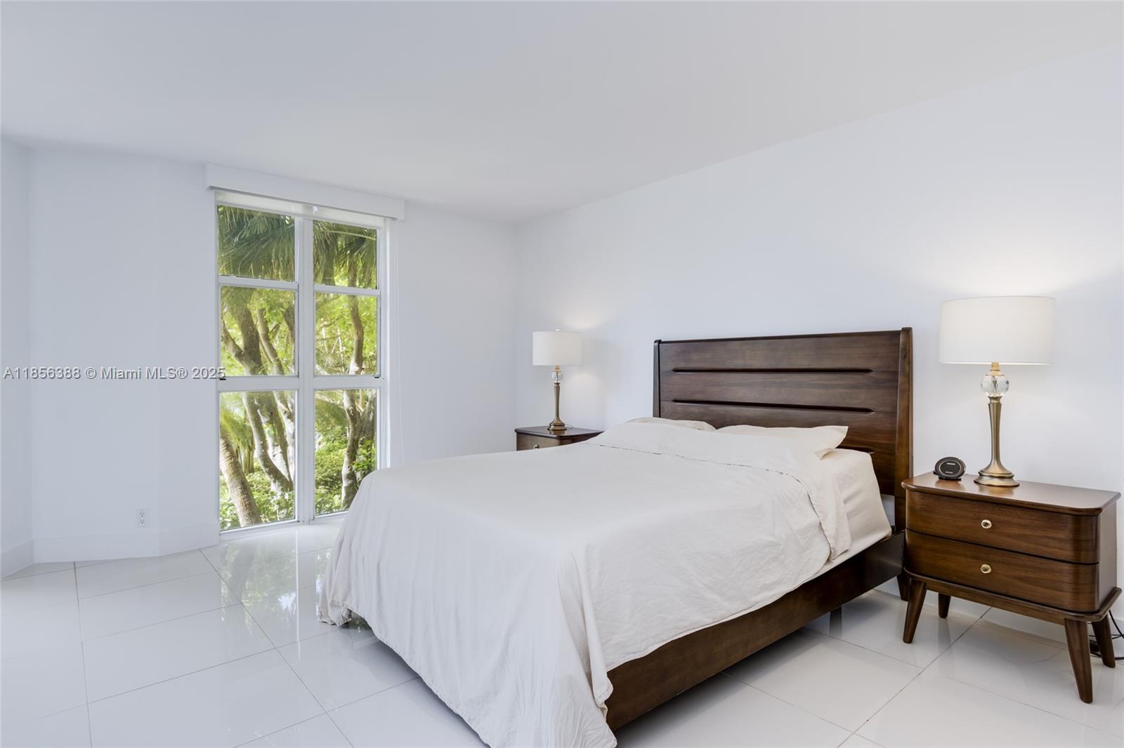 2000 Towerside Terrace, Unit 406 Miami, FL 33138 - Photo 21 of 56 a bedroom with a bed and a window