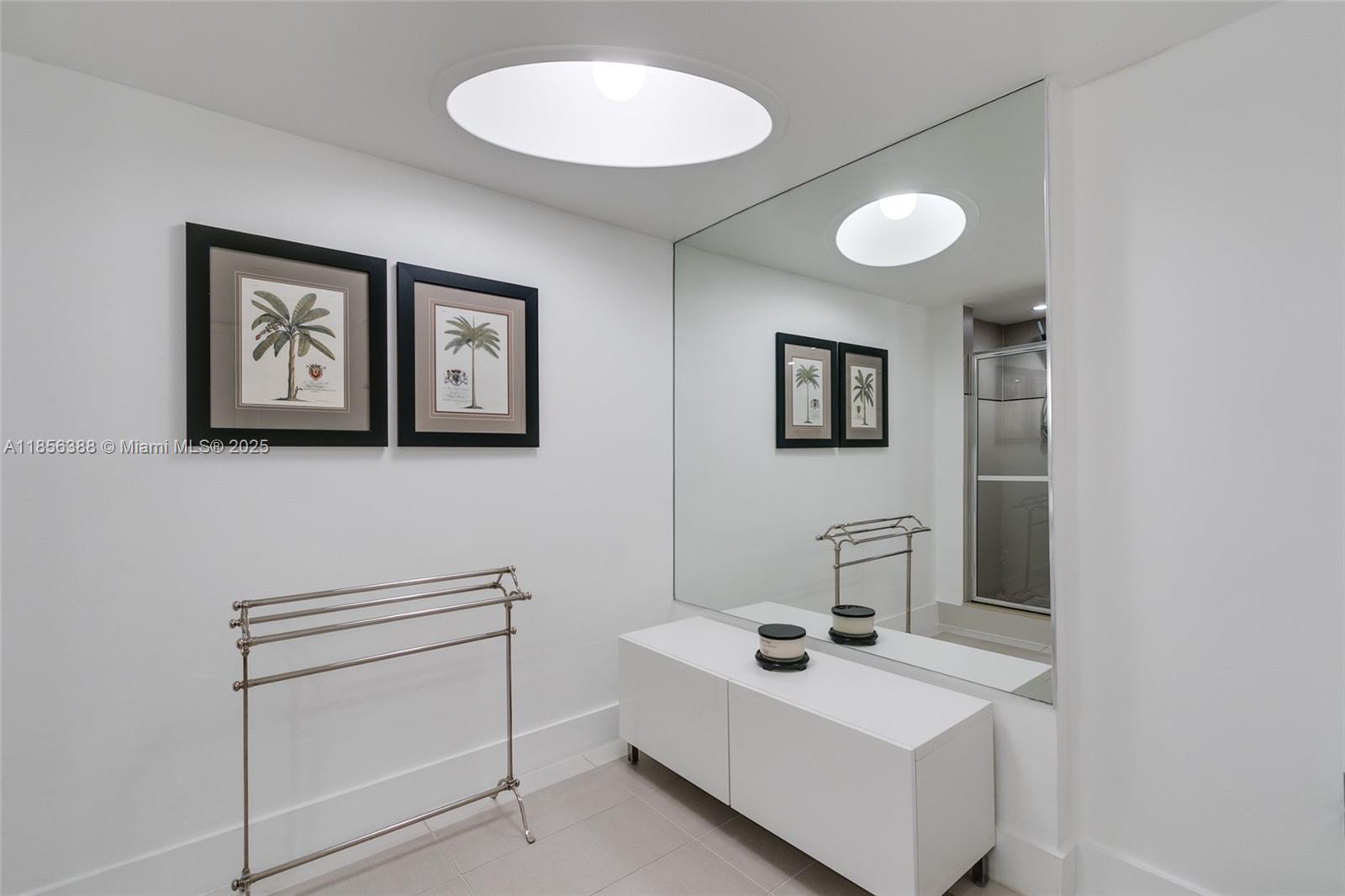 2000 Towerside Terrace, Unit 406 Miami, FL 33138 - Photo 25 of 56 a bathroom with a sink and a mirror