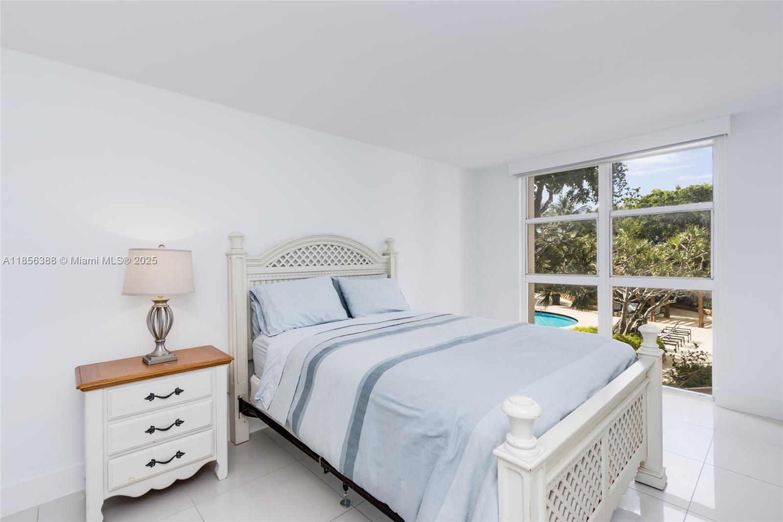 2000 Towerside Terrace, Unit 406 Miami, FL 33138 - Photo 29 of 56 a bedroom with a bed and a window