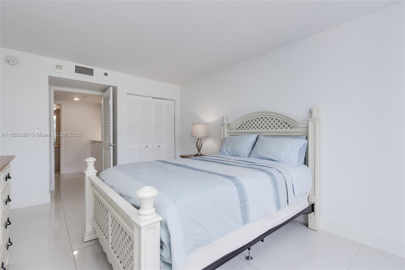 2000 Towerside Terrace, Unit 406 Miami, FL 33138 - Photo 31 of 56 a bedroom with a bed and a night stand
