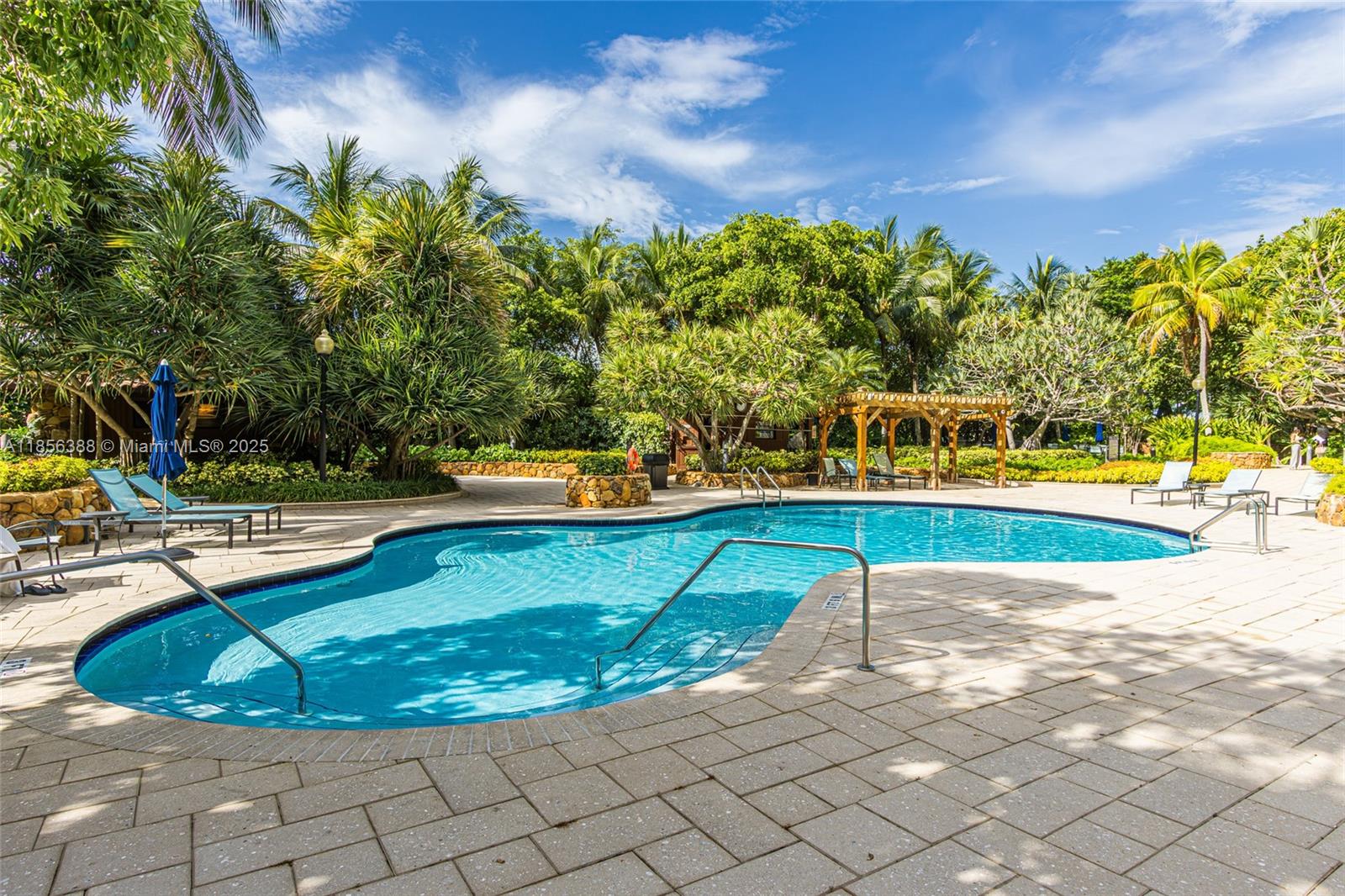 2000 Towerside Terrace, Unit 406 Miami, FL 33138 - Photo 36 of 56 a view of a swimming pool with a lounge chair