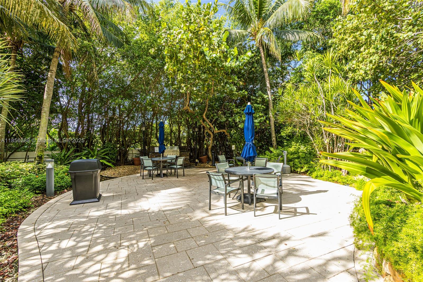 2000 Towerside Terrace, Unit 406 Miami, FL 33138 - Photo 38 of 56 a view of a patio with a table and chairs and potted plants