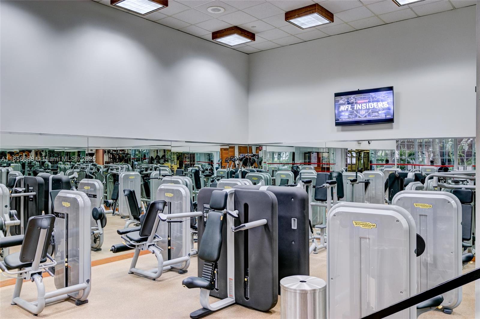 2000 Towerside Terrace, Unit 406 Miami, FL 33138 - Photo 42 of 56 a room with gym equipment and large mirror