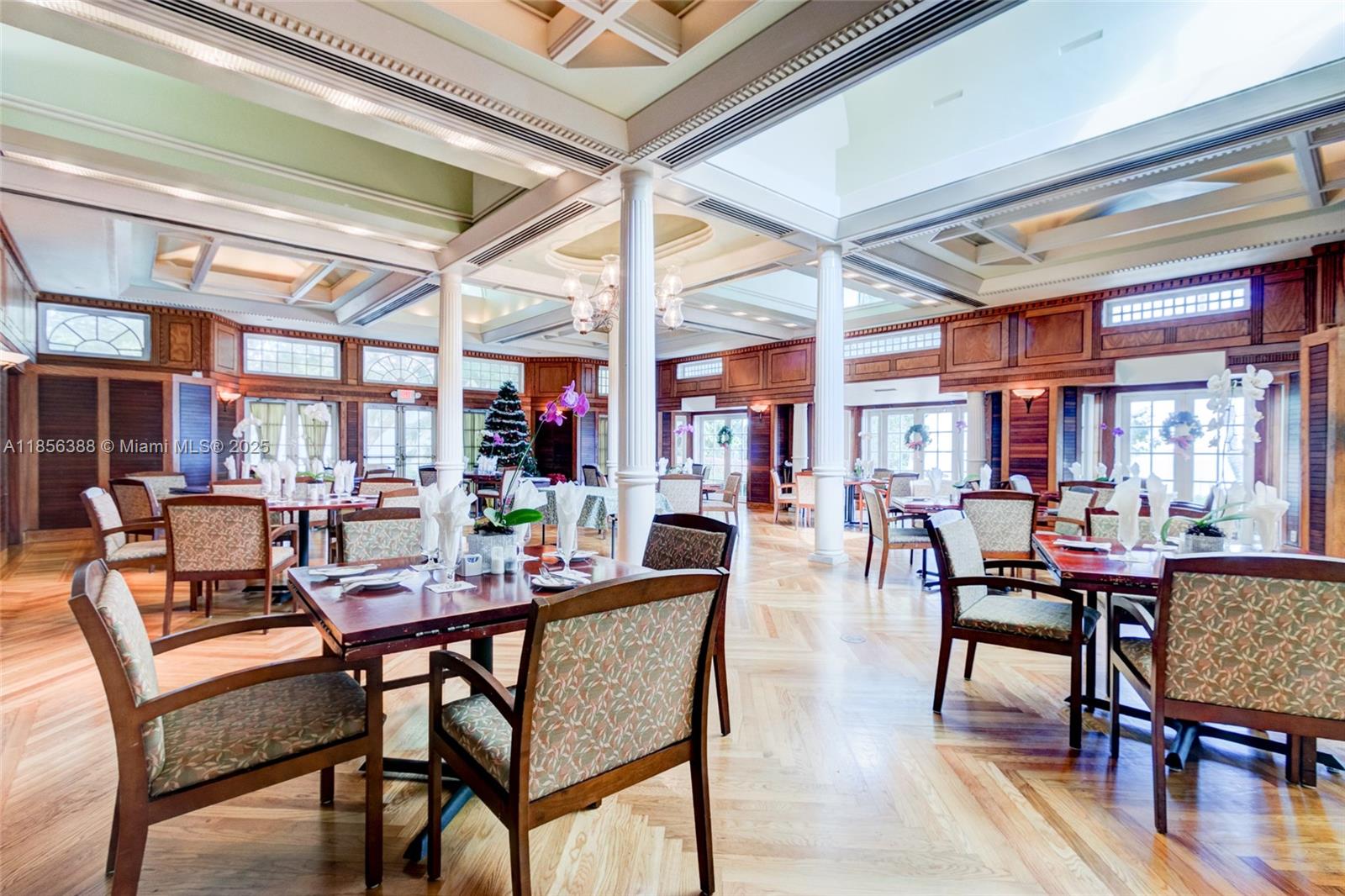 2000 Towerside Terrace, Unit 406 Miami, FL 33138 - Photo 47 of 56 a dining room with furniture and wooden floor