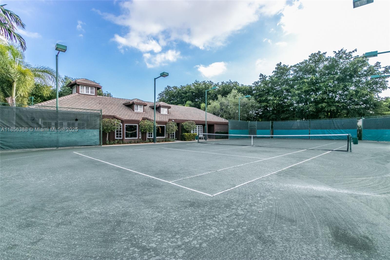 2000 Towerside Terrace, Unit 406 Miami, FL 33138 - Photo 48 of 56 a view of a tennis ground with a large trees