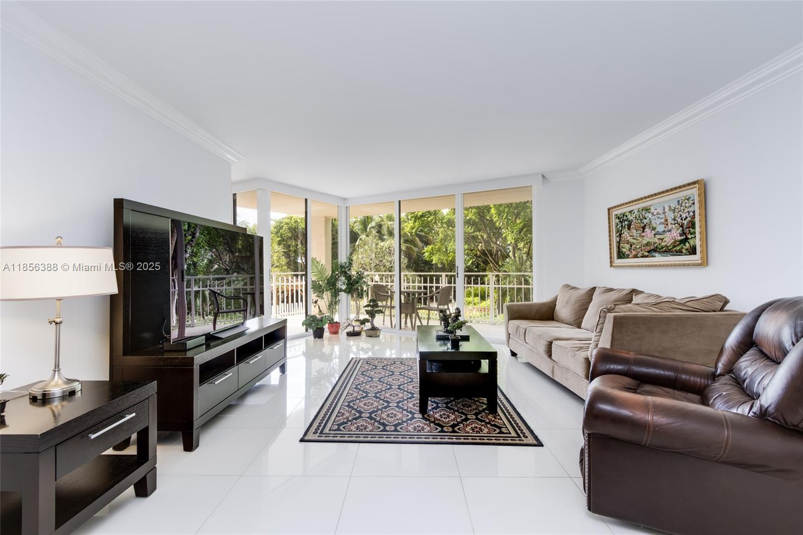 2000 Towerside Terrace, Unit 406 Miami, FL 33138 - Photo 7 of 56 a living room with furniture floor to ceiling window and a flat screen tv