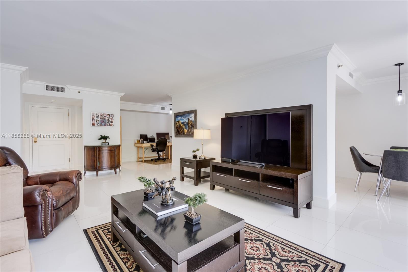 2000 Towerside Terrace, Unit 406 Miami, FL 33138 - Photo 9 of 56 a living room with furniture and a flat screen tv
