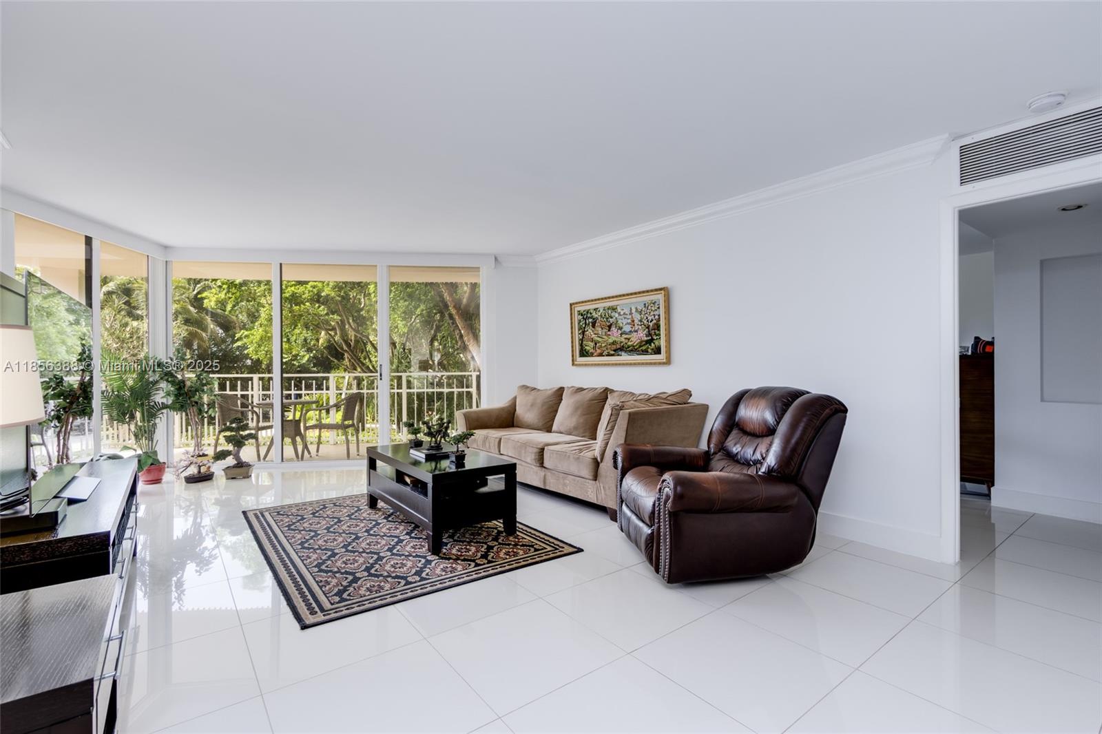 2000 Towerside Terrace, Unit 406 Miami, FL 33138 - Photo 10 of 56 a living room with furniture and a floor to ceiling window