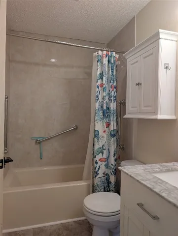 a view of a room with wooden floor and fan