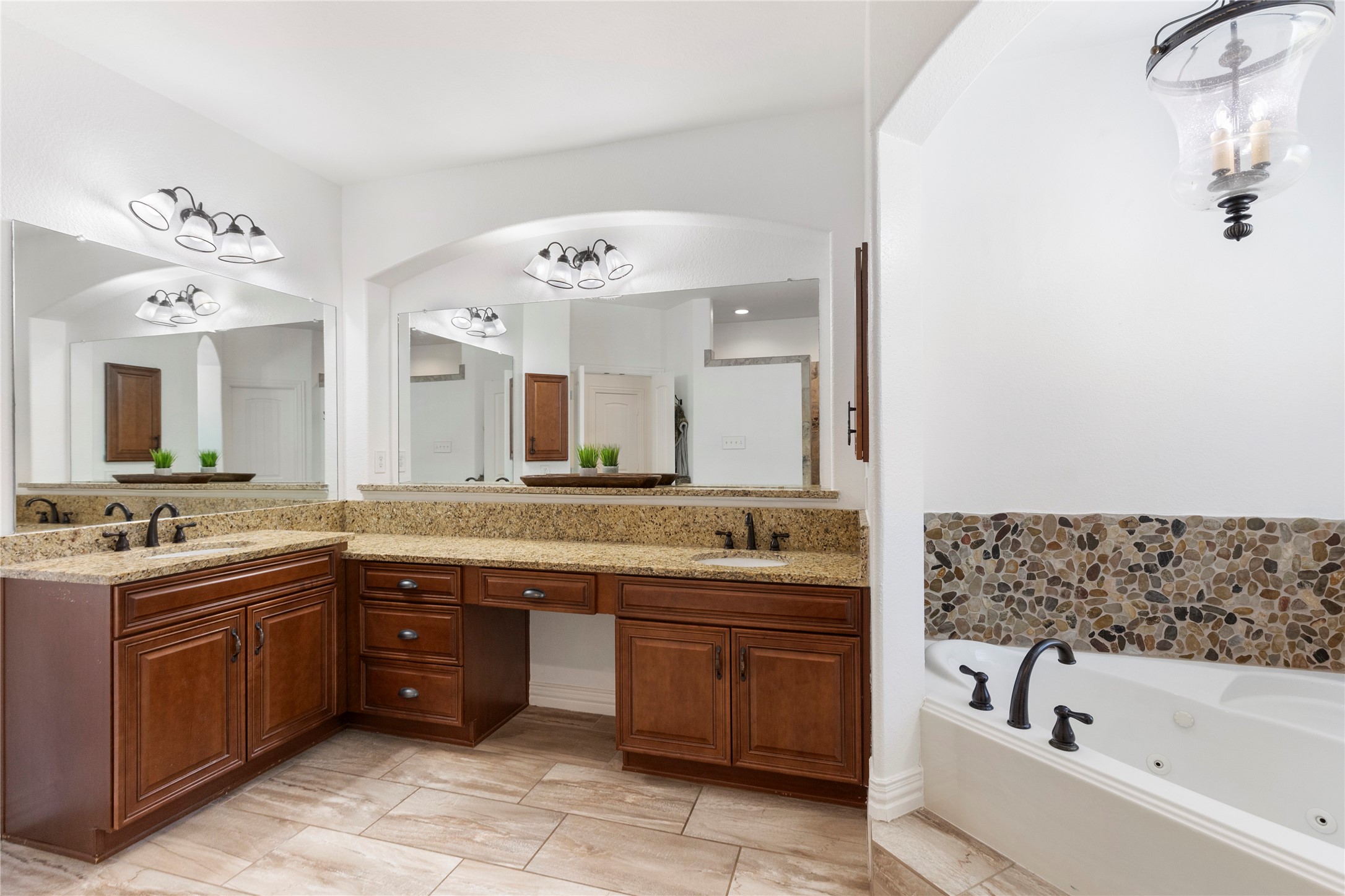 36345 Lady J Circle Wallis, TX 77485 - Photo 27 of 50 a bathroom with a tub a sink double vanity and a mirror